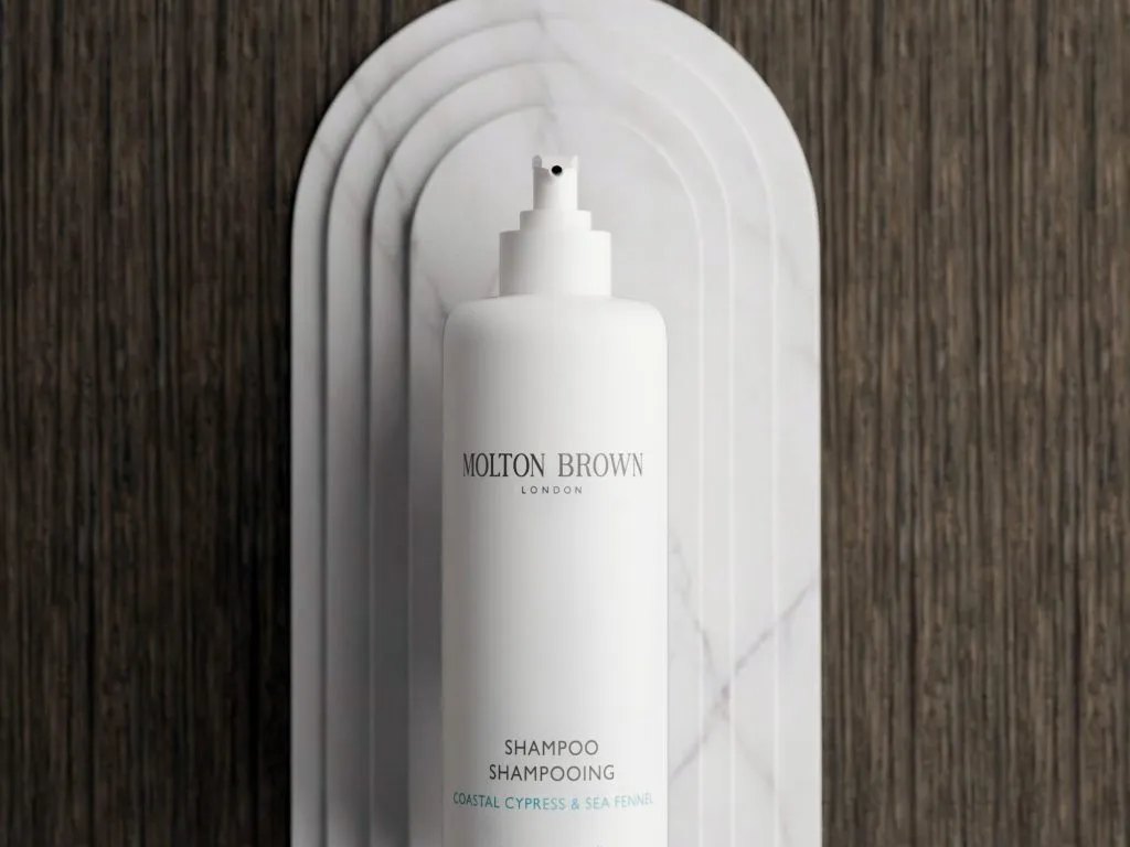 Molton Brown bottle mounted on a sculpted marble floating backplate