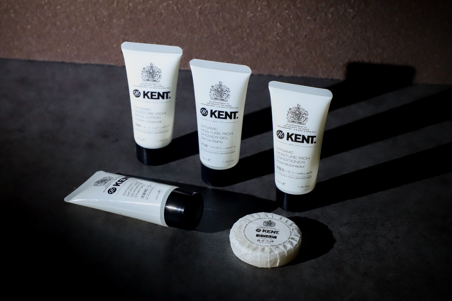The Kent Dynamic Moisture Rich hotel amenity set — 30ml shampoo, conditioner, shower gel and body lotion tubes with a wrapped 25g soap