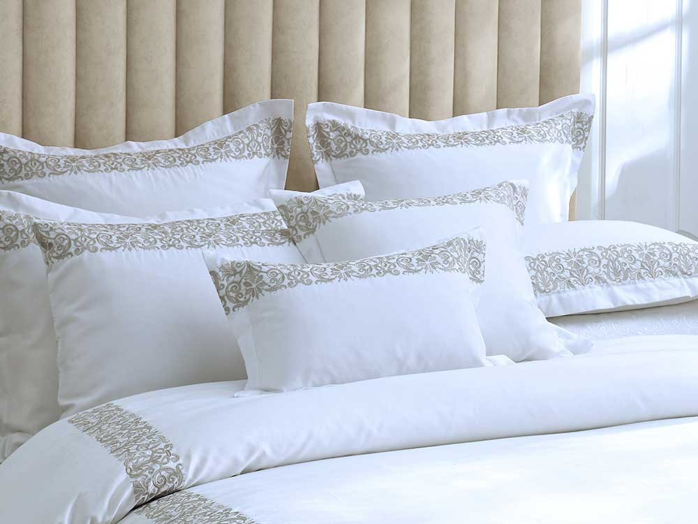 Muir Fion bedding in white 500 thread count Egyptian cotton sateen with a taupe embroidered border