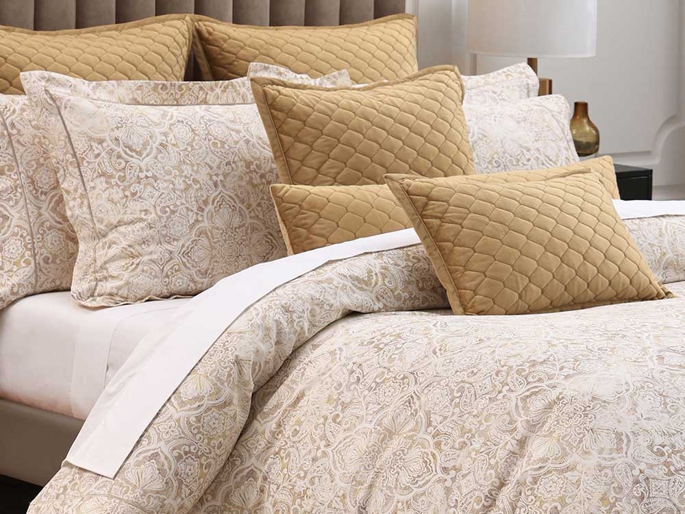 Muir Mayfair printed bedding with quilted gold velvet cushions