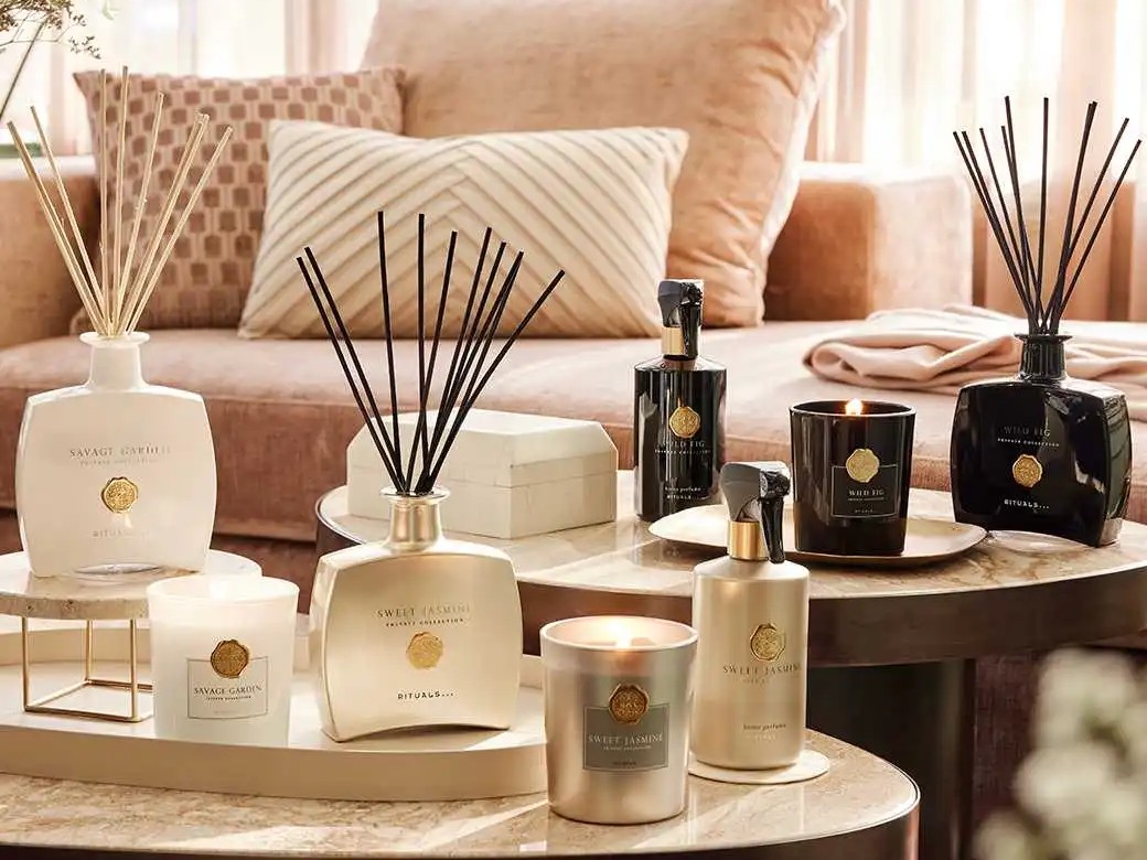 Rituals Private Collection reed diffusers, home perfume sprays and candles arranged on a marble table