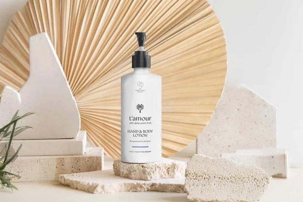 T’amour hand and body lotion with date palm fruit, Rosewood and Amber, on limestone